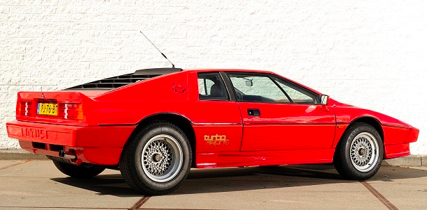 lotus esprit turbo hc parked in front of brick wall